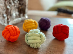 Colorful cotton knot toys in red, orange, yellow, purple, and green, ideal for playful pets or decorative use.